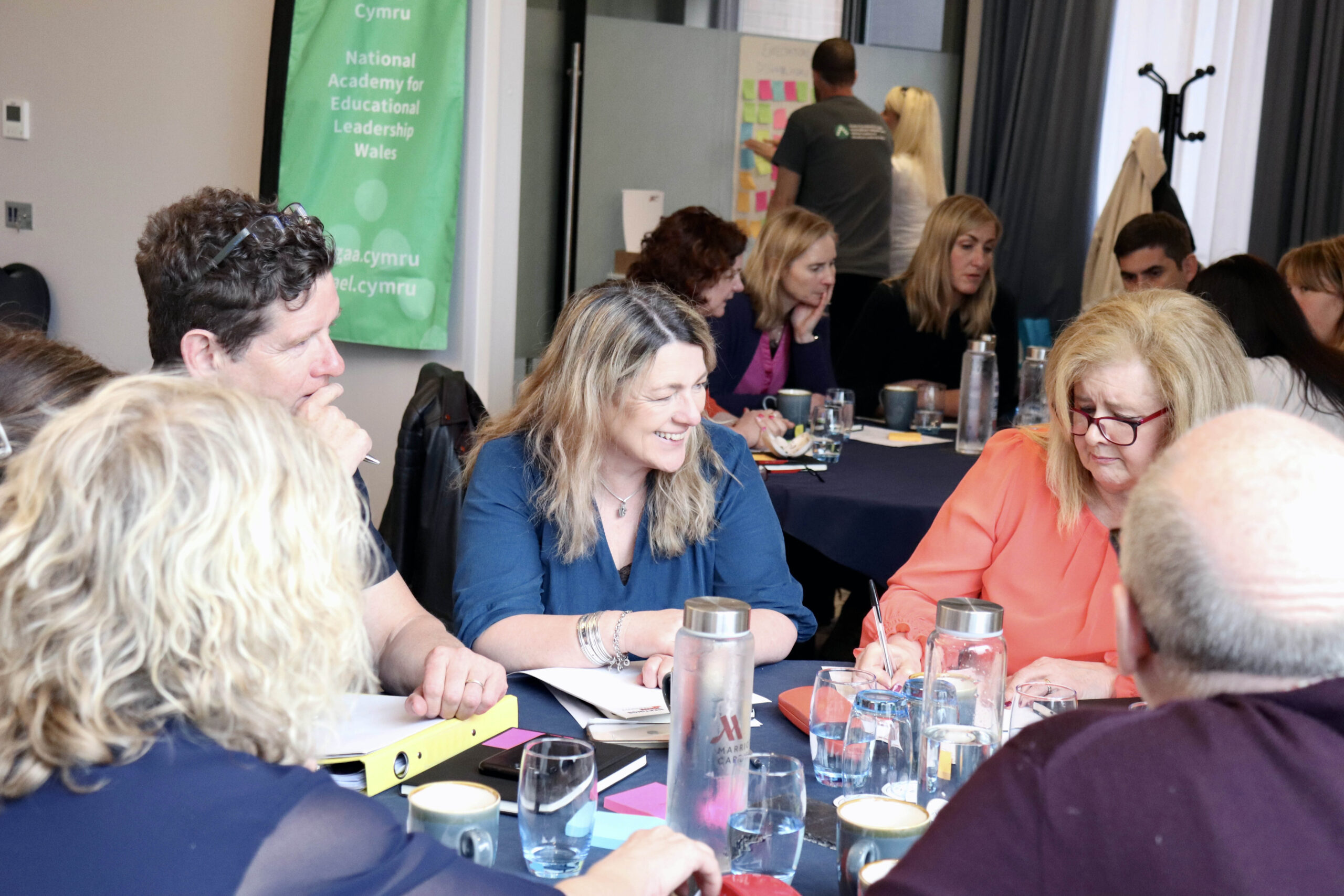 A group of educational leaders sitting around a table and discussing
