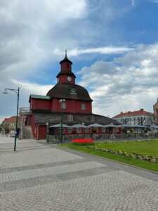 A red building with a clock tower in Sweden.