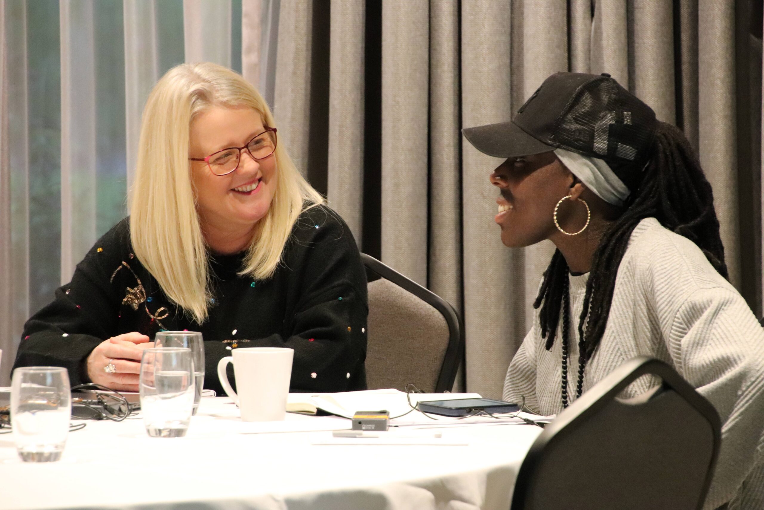 Two leaders in discussion around a table